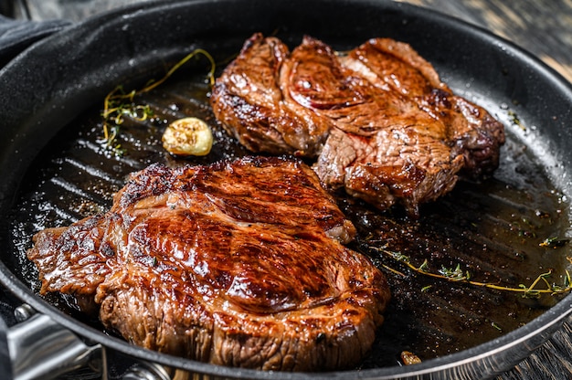 Premium Photo | Cooked grilled marble steak chuck roll in a pan.