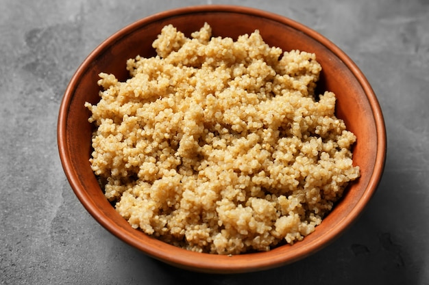Cooked quinoa in bowl on grey surface Premium Photo