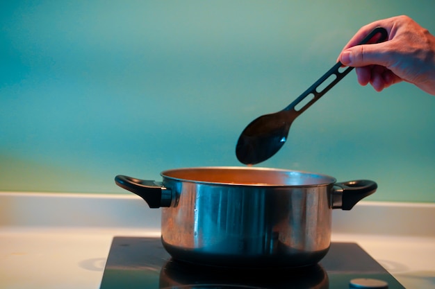 Cooking soup in a pan on an induction stove Premium Photo