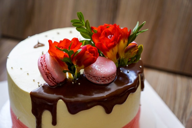 Cooking Sponge Cake Decorated With Fresh Flowers And Biscuit