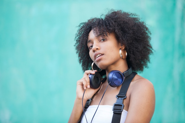 Premium Photo | Cool urban black woman listening music on the street