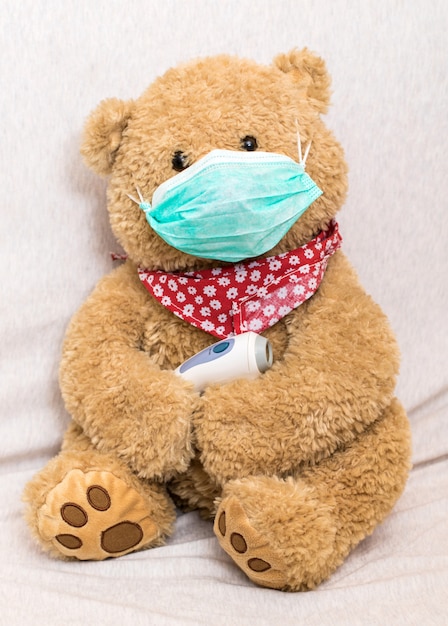 Premium Photo | Coronavirus concept: teddy bear with medical mask hold ...