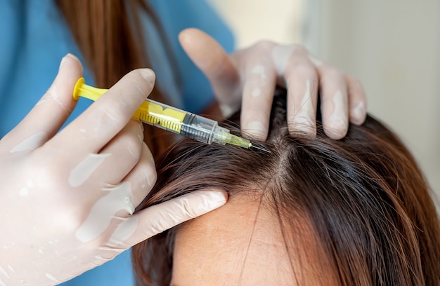 Premium Photo | Cosmetic injection to the head in the clinic