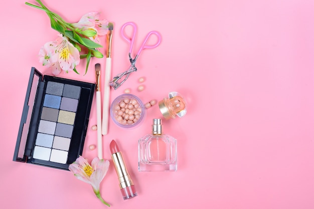 Premium Photo | Cosmetics and flowers on a pink surface. beauty concept.