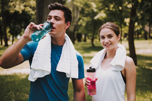 Premium Photo | Couple of athletes after training in green park