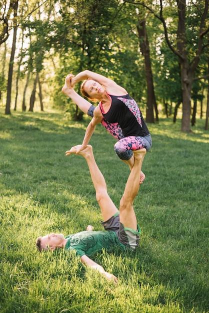 Free Photo | Couple balancing and stretching muscle while doing acro yoga