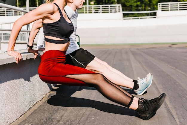 Couple doing reverse triceps exercises Free Photo