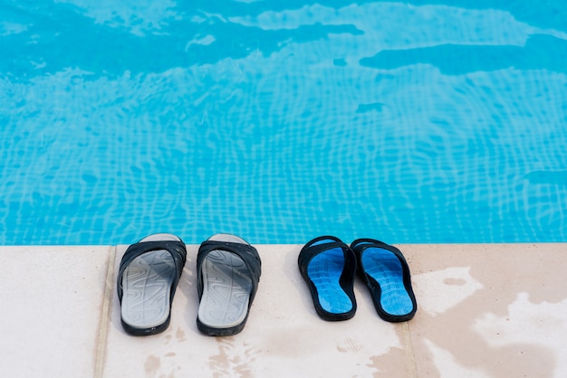 Premium Photo | Couple of flip flops near pool