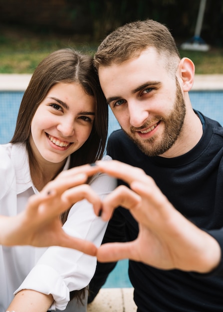 Free Photo Couple Forming Heart With Hands