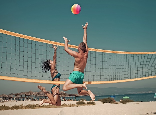 Premium Photo Couple Have Fun Playing Volleyball Young Sporty Active Couple Beat Off Volley