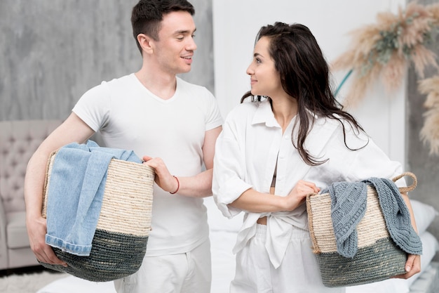 Free Photo | Couple holding baskets together