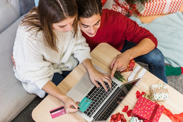 Couple looking at laptop screen Free Photo