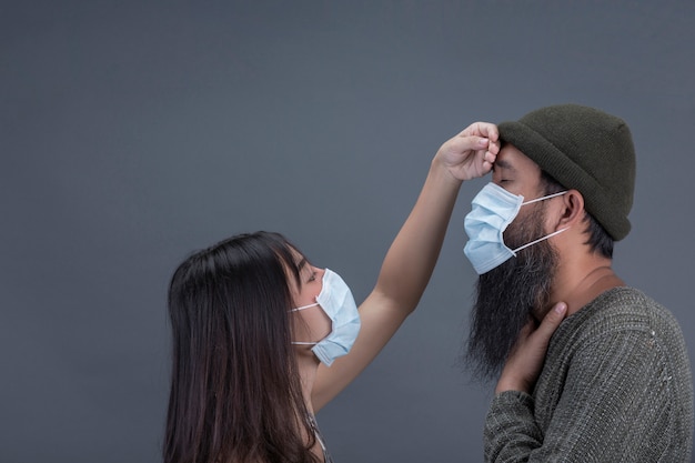 Free Photo Couple Love Are Wearing Mask While Care Togther From Sick On Gray Wall