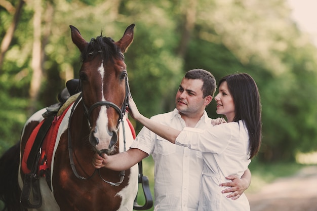 Free Photo | Couple petting a horse