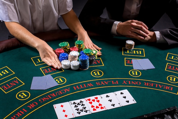 Premium Photo | Couple playing poker at the table. the blonde girl and ...