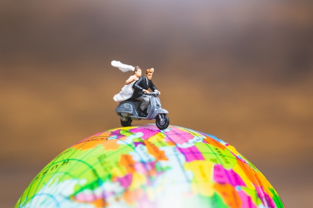Couple riding the motorcycle on the globe , valentines concept Premium Photo