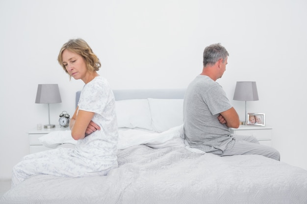 Premium Photo Couple Sitting On Different Sides Of Bed Not Talking