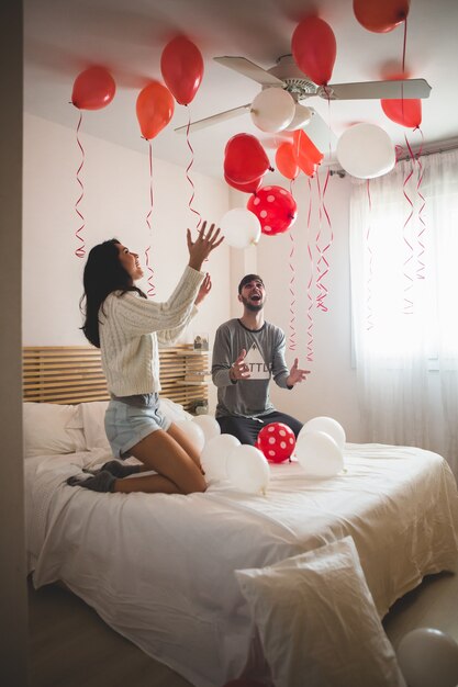 Couple Smiling With Hands Raised Looking At The Ceiling Full