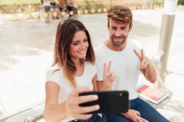 Free Photo Couple Taking A Selfie And Showing Peace Sign