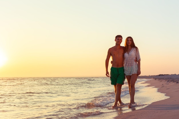 Premium Photo | Couple taking a walk on the beach