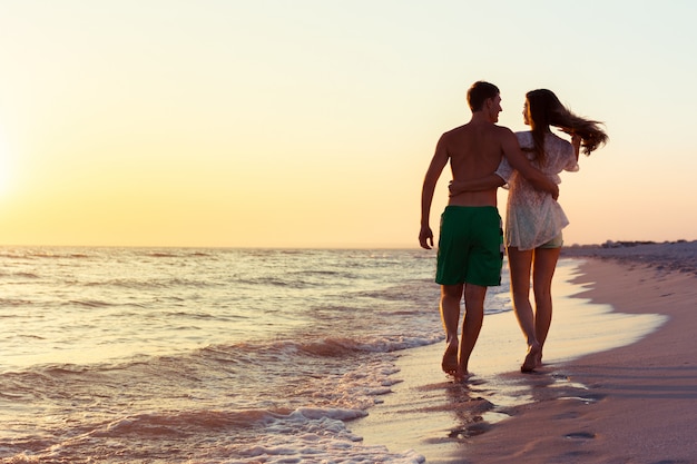 Premium Photo | Couple taking a walk on the beach