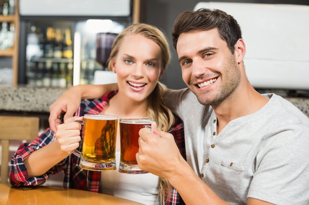 Premium Photo | Couple toasting with beers