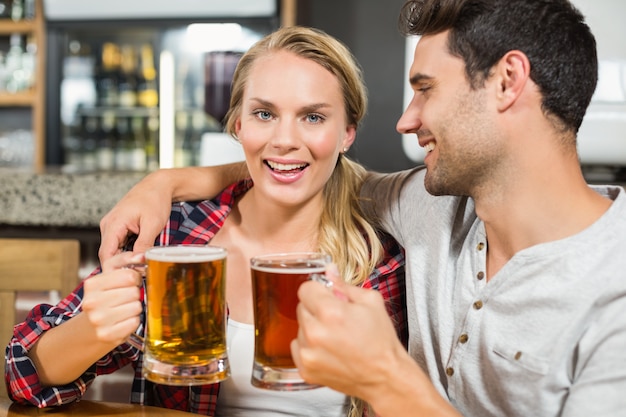 Premium Photo | Couple toasting with beers