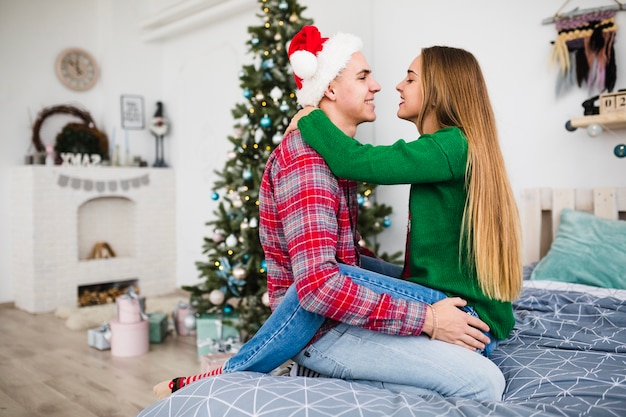 Free Photo | Couple together on bed at christmas