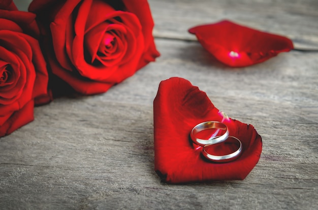 Premium Photo | Couple wedding rings on red rose petal with red rose ...