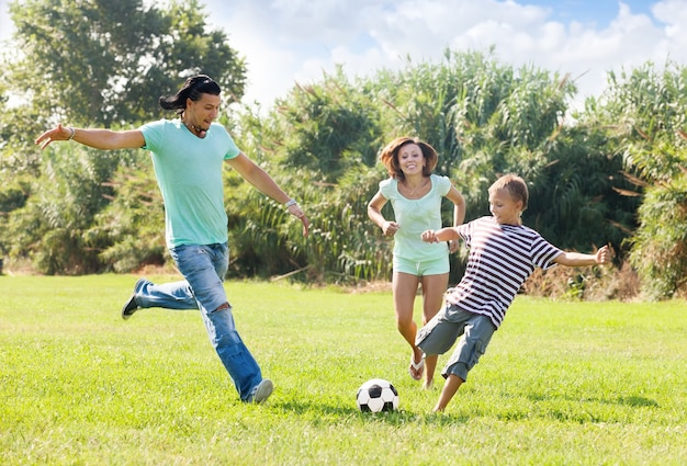 Couple with son playing with soccer ball Free Photo
