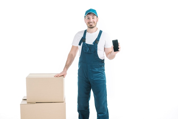 Free Photo Courier With Smartphone Near Parcels