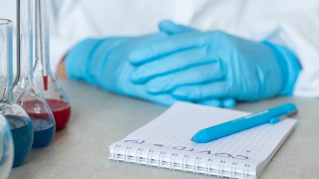 Premium Photo Covid Hands Of A Chemist Or Virologist Notebook