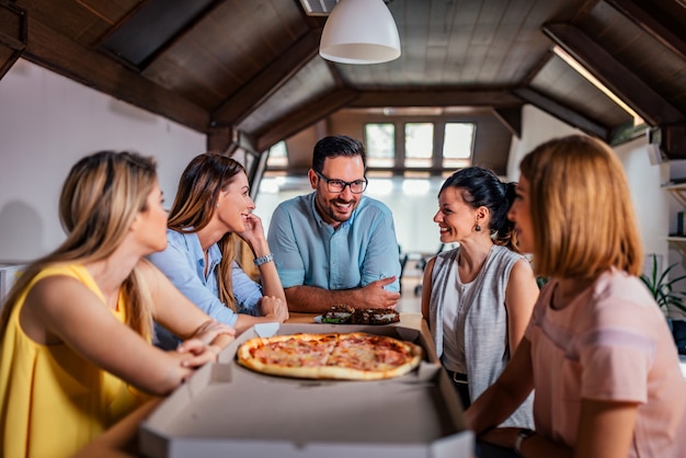 Coworkers Eating Pizza During Work Break At Modern Office Premium Photo