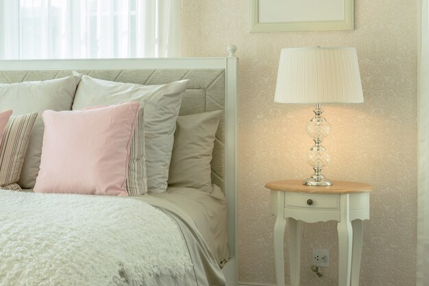 Cozy Bedroom Interior With Pink Pillows And Reading Lamp On Bedside Table Premium Photo