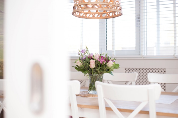 Cozy Dining Room Interior With Flower Decoration In A White Room