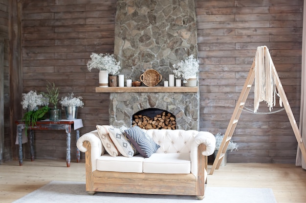 Premium Photo Cozy Interior Living Room White Sofa And Fireplace Rustic Home Design For Warm Indoor Space Alpine Vacation Modern Cottage Living Room Decor With Wood Wall And Furniture Scandinavian Style
