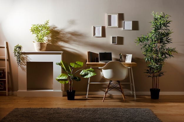 Cozy room with wooden desk and laptop Free Photo