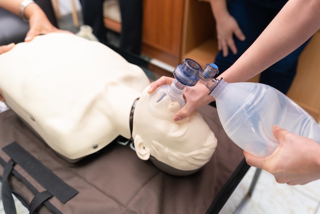 Premium Photo | Cpr training with cpr doll and am-bu bag for ...