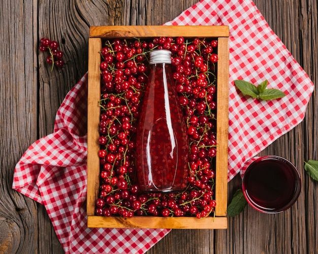 Cranberry juice bottle on wooden background Free Photo