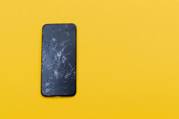 premium-photo-crashed-smartphone-on-a-yellow-background