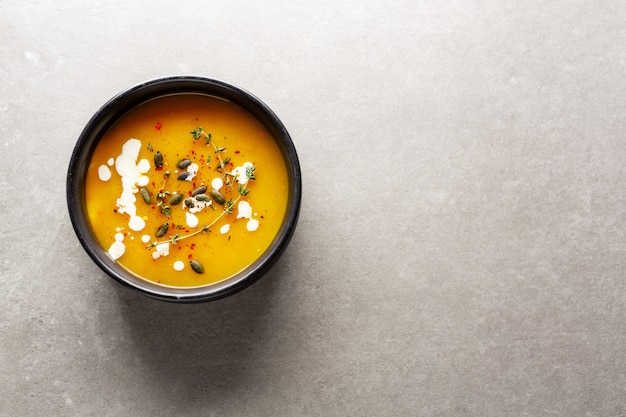 Creamy pumpkin soup served in bowl Free Photo