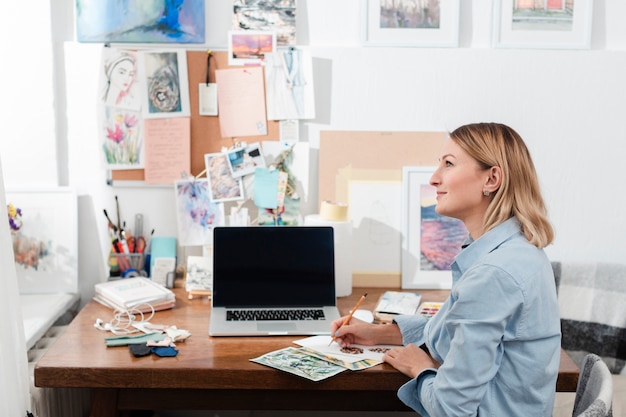 Free Photo | Creative artist sitting at desk