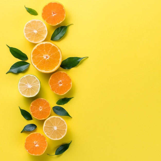 Creative background with tropical fruits. orange, lemon, lime, grapefruit Premium Photo