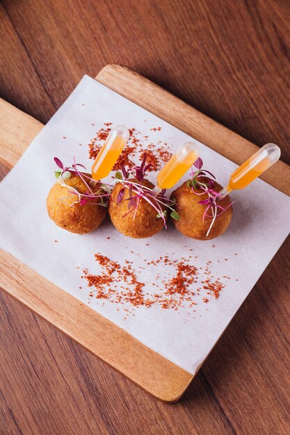 Premium Photo | Creative fine dining: chicken biryani arancini served ...