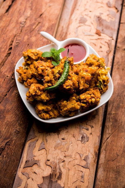 Premium Photo | Crispy corn pakora or pakoda, bhajji, bhaji, bajji or ...