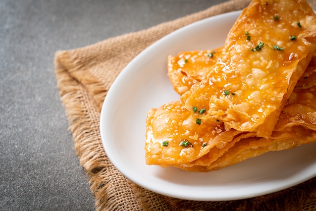 Premium Photo | Crispy roti with sugar on plate