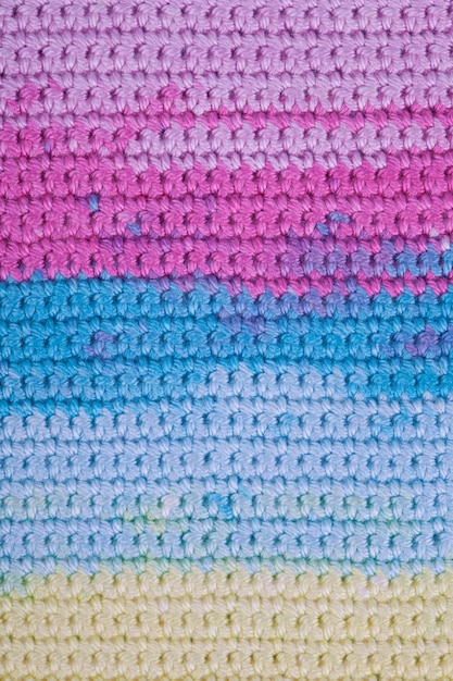 Crochet, handmade, needlework. close up macro background texture of striped knitted texture. diy Premium Photo