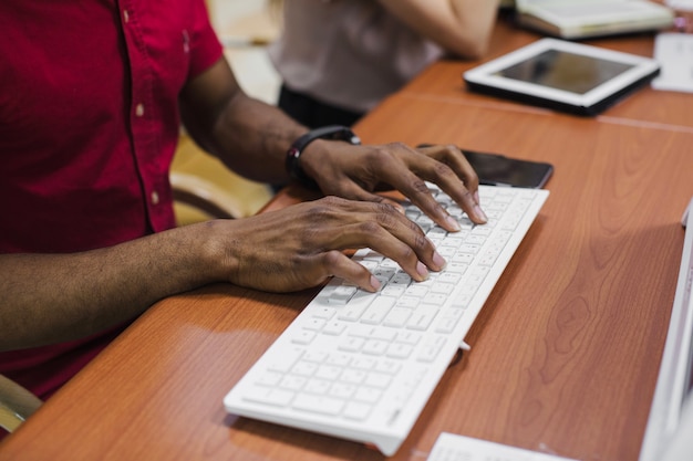 Free Photo | Crop black man typing on keyboard