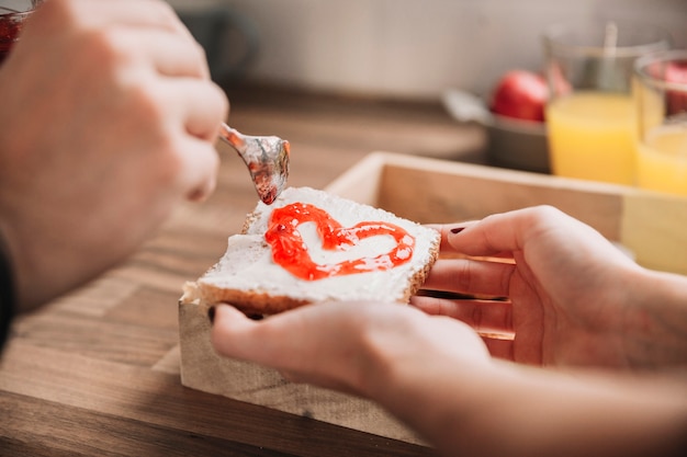 Crop couple making toast with jam Free Photo Crop couple making toast with jam Free Photo