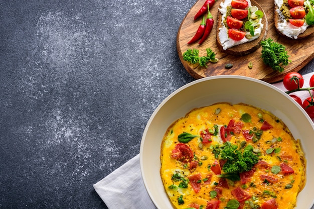 Premium Photo | Crop healthy breakfast of omelet with cherry tomatoes ...